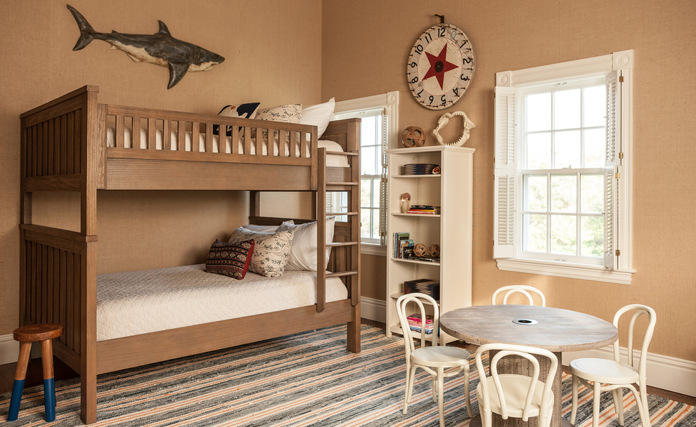 This is an example of a mid-sized beach style gender-neutral kids' bedroom for kids 4-10 years old in Boston with brown walls.