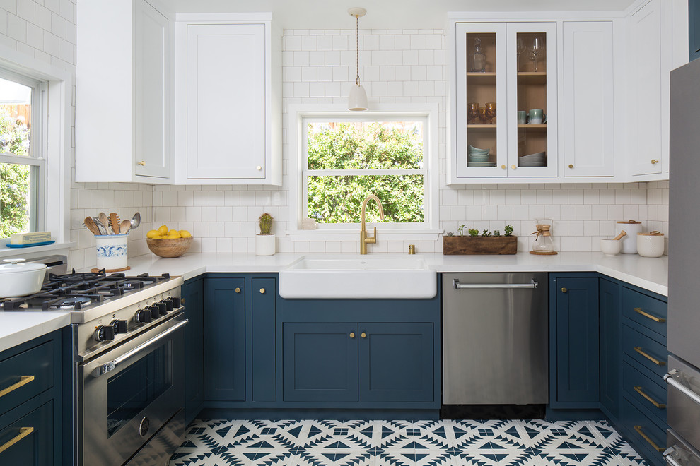 Mid-sized arts and crafts u-shaped separate kitchen in San Francisco with a farmhouse sink, shaker cabinets, blue cabinets, quartz benchtops, white splashback, ceramic splashback, stainless steel appliances, cement tiles, no island and blue floor.