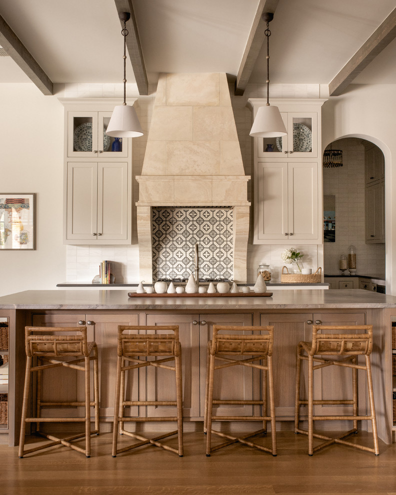 This is an example of a transitional galley kitchen in Dallas with shaker cabinets, beige cabinets, ceramic splashback, medium hardwood floors, with island and grey benchtop.