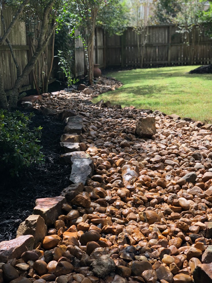 Inspiration for a rustic partial sun backyard landscaping in Houston.