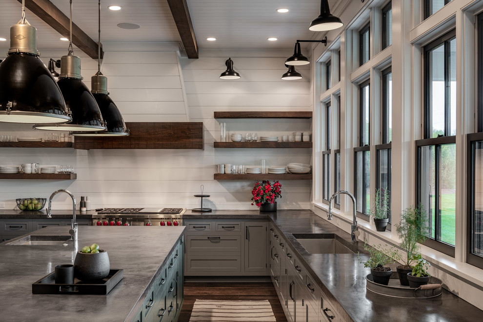 This is an example of a large country u-shaped eat-in kitchen in New York with a single-bowl sink, shaker cabinets, grey cabinets, concrete benchtops, white splashback, timber splashback, stainless steel appliances, dark hardwood floors, with island, brown floor and black benchtop.