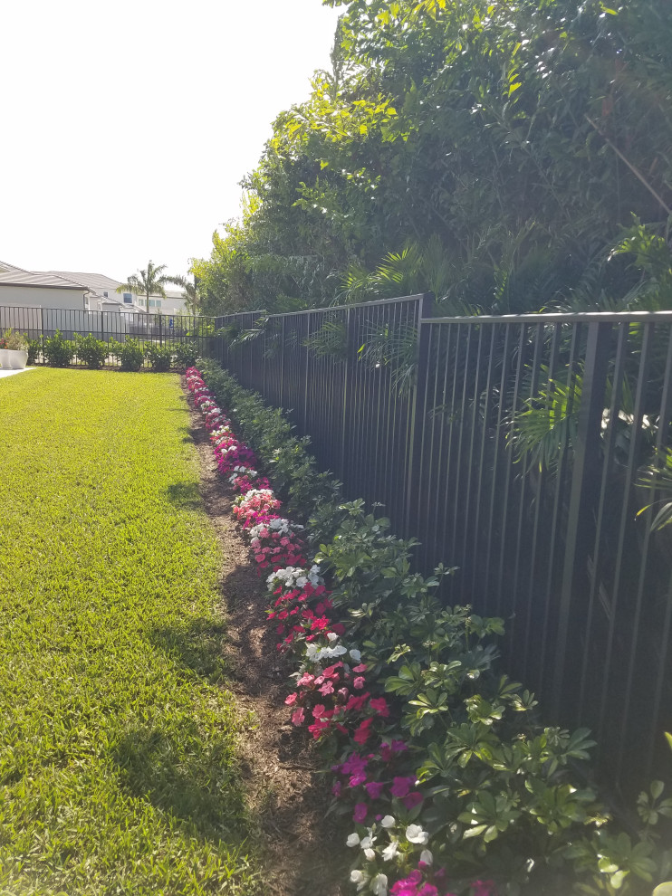 Front yard garden in Miami with a garden path and river rock.