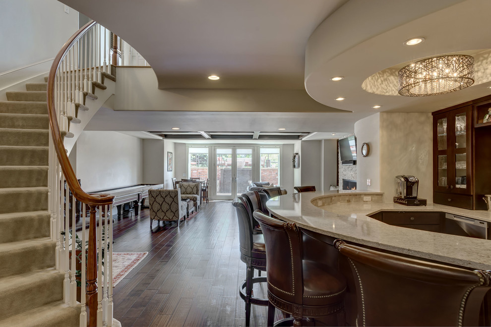 Large transitional look-out basement in Denver with grey walls, dark hardwood floors, no fireplace and brown floor.