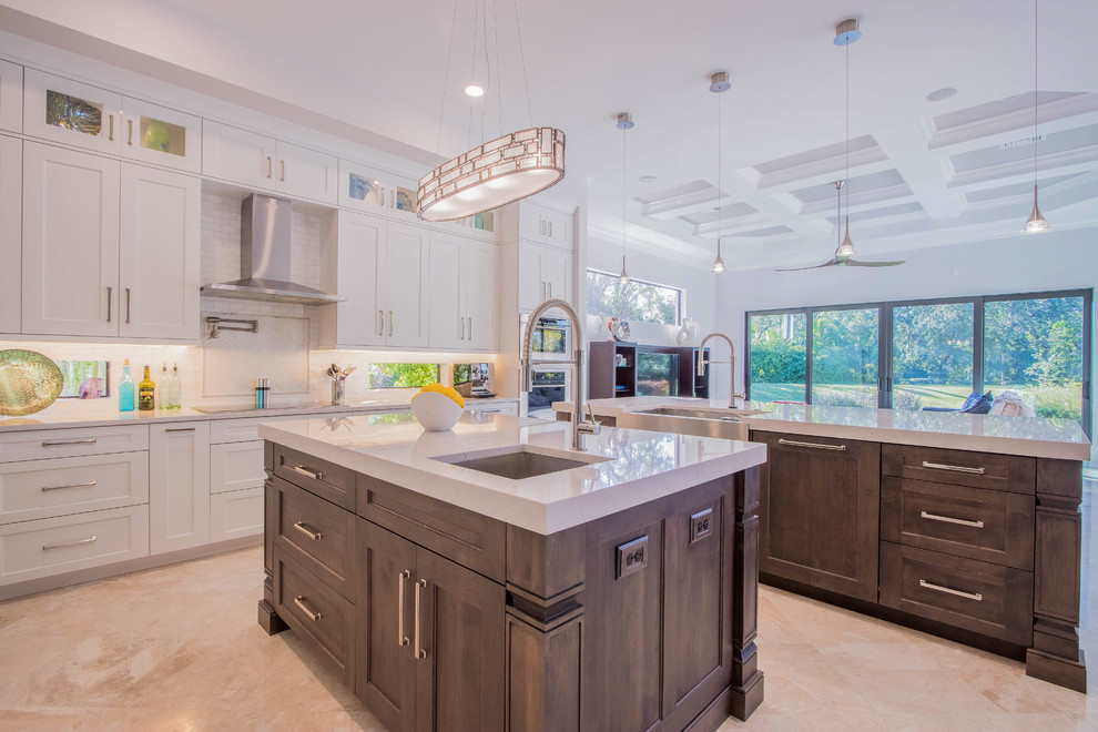 Inspiration for a huge transitional l-shaped porcelain tile and beige floor open concept kitchen remodel with a farmhouse sink, shaker cabinets, white cabinets, quartz countertops, white backsplash, porcelain backsplash, stainless steel appliances and two islands