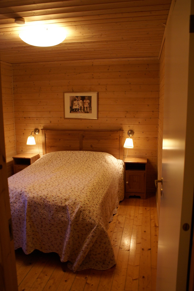 This is an example of a traditional bedroom in Other with light hardwood floors.