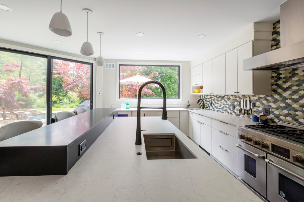 Large 1960s porcelain tile and gray floor kitchen pantry photo in New York with an undermount sink, flat-panel cabinets, white cabinets, quartz countertops, ceramic backsplash, paneled appliances, an island and white countertops