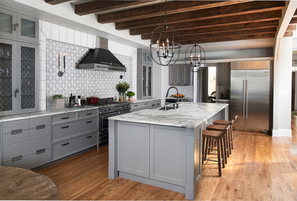 Inspiration for a large transitional l-shaped eat-in kitchen in Atlanta with an undermount sink, grey cabinets, marble benchtops, grey splashback, porcelain splashback, stainless steel appliances, medium hardwood floors, with island, grey benchtop, recessed-panel cabinets and brown floor.