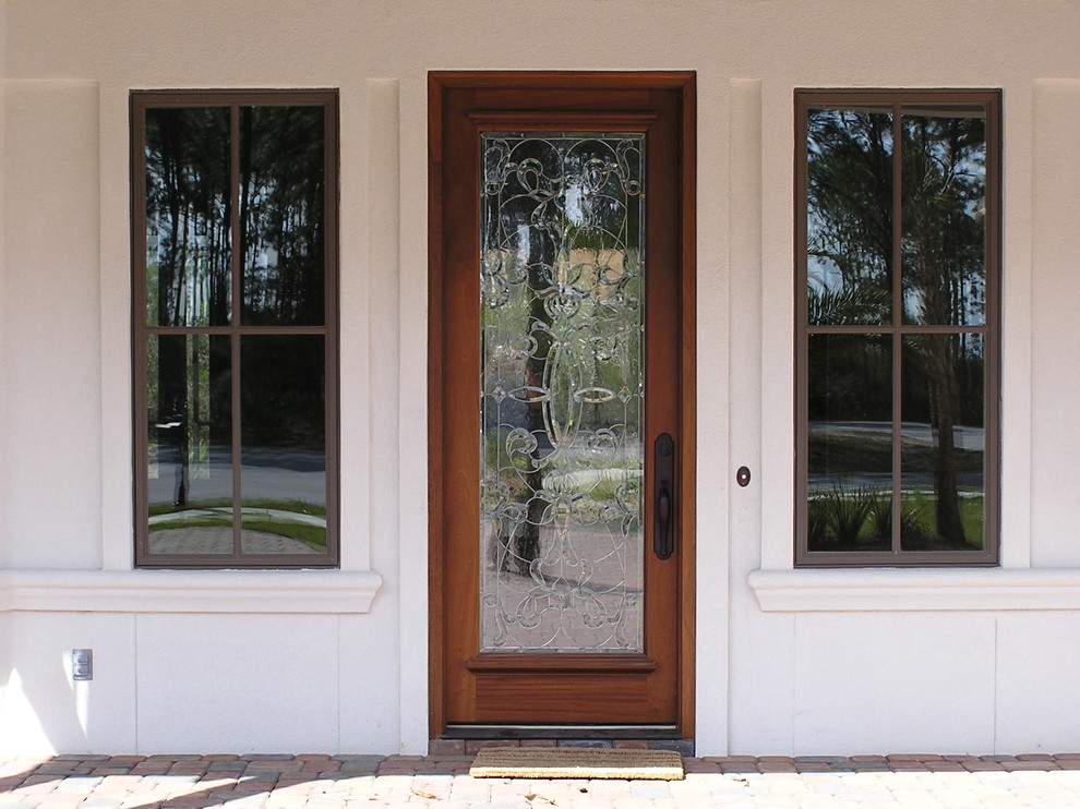 Front door - mid-sized rustic brick floor front door idea in Miami with white walls and a glass front door