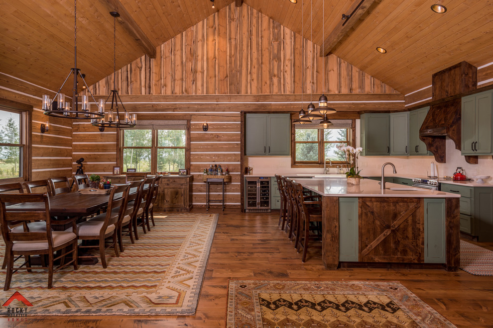 Mid-sized mountain style medium tone wood floor and brown floor kitchen/dining room combo photo with blue walls