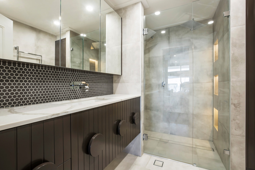 This is an example of a mid-sized contemporary master bathroom in Sydney with furniture-like cabinets, white cabinets, an alcove shower, a one-piece toilet, beige tile, porcelain tile, beige walls, porcelain floors, a vessel sink, engineered quartz benchtops, beige floor and a hinged shower door.