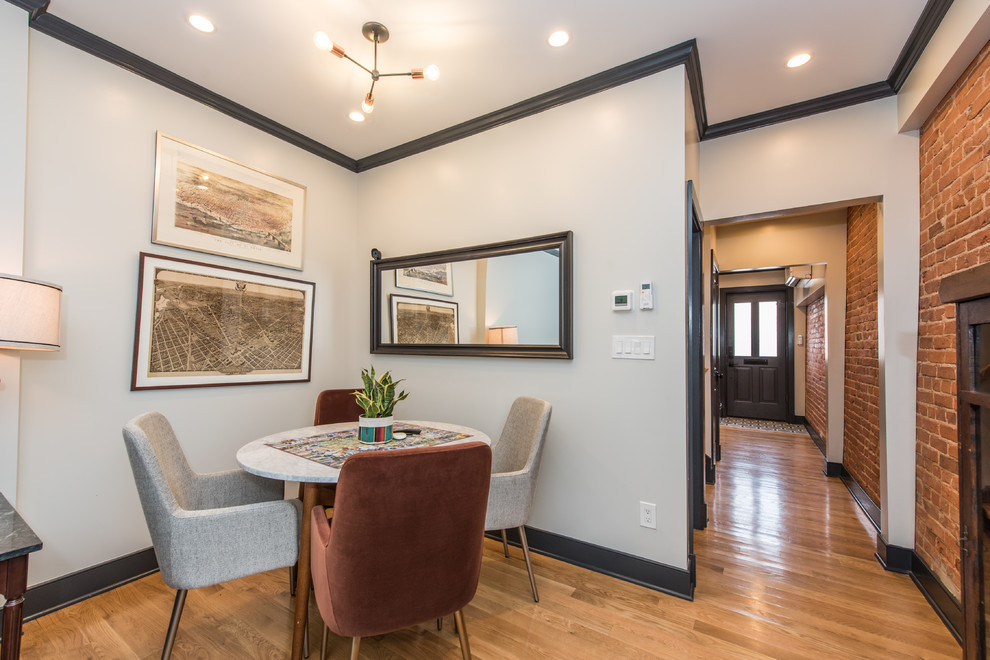 Small transitional open plan dining in DC Metro with grey walls, medium hardwood floors and brown floor.