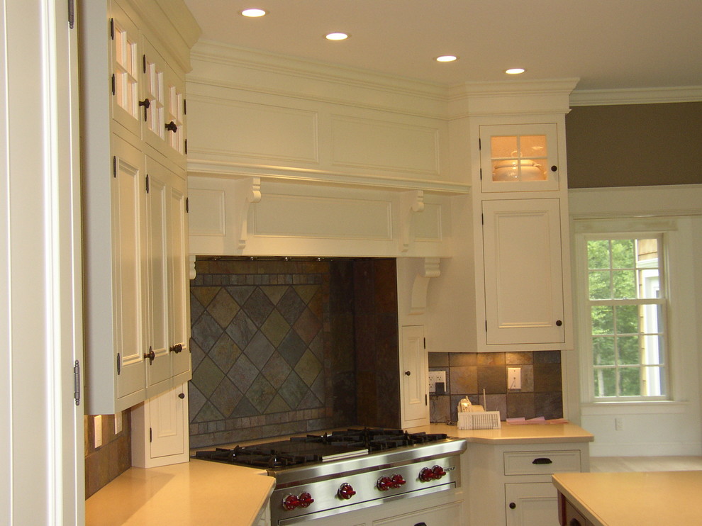 Photo of a large traditional l-shaped eat-in kitchen in Bridgeport with shaker cabinets, white cabinets, stainless steel appliances and with island.