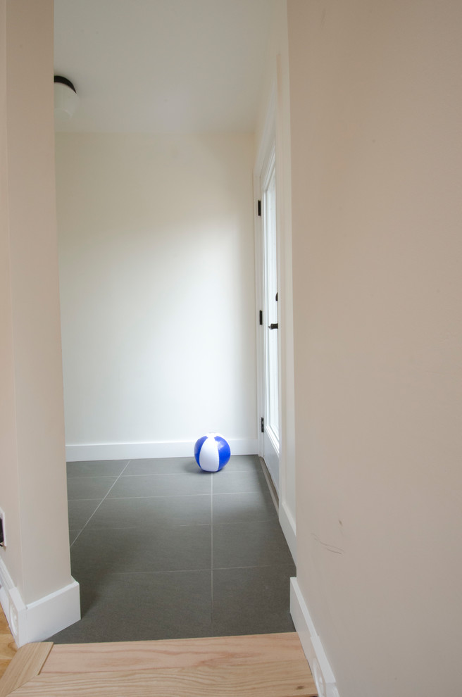 Basement - mid-sized transitional look-out laminate floor and beige floor basement idea in Toronto with white walls