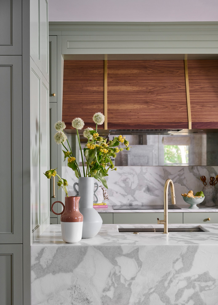 Example of a mid-sized transitional galley medium tone wood floor and brown floor open concept kitchen design in Atlanta with an undermount sink, recessed-panel cabinets, green cabinets, marble countertops, white backsplash, marble backsplash, paneled appliances, an island and white countertops