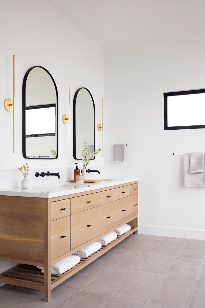 Large trendy master gray tile and porcelain tile porcelain tile, gray floor and double-sink bathroom photo in San Francisco with brown cabinets, white walls, an undermount sink, quartz countertops, a hinged shower door, white countertops, a freestanding vanity and flat-panel cabinets