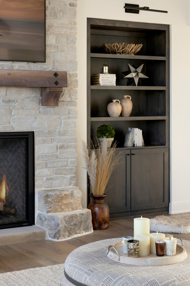 Example of a minimalist living room design in Minneapolis with a stone fireplace