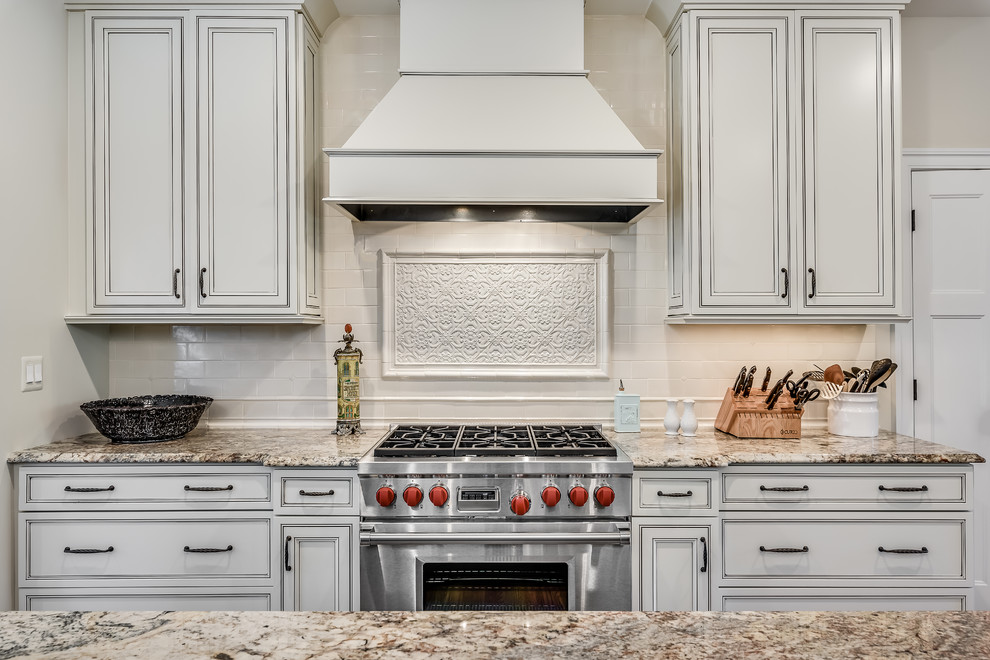 Design ideas for a large arts and crafts u-shaped open plan kitchen in DC Metro with shaker cabinets, white cabinets, granite benchtops, white splashback, subway tile splashback, stainless steel appliances, dark hardwood floors and with island.