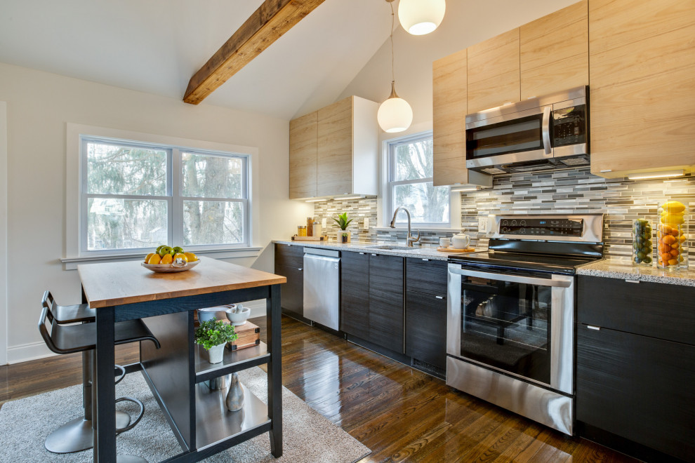 Eat-in kitchen - small transitional galley dark wood floor, brown floor and exposed beam eat-in kitchen idea in Wilmington with an undermount sink, flat-panel cabinets, light wood cabinets, granite countertops, metallic backsplash, mosaic tile backsplash, stainless steel appliances, an island and multicolored countertops