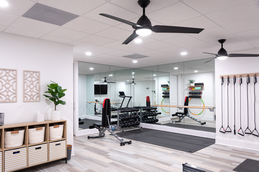 Design ideas for a medium sized contemporary multi-use home gym in Raleigh with white walls, vinyl flooring and grey floors.