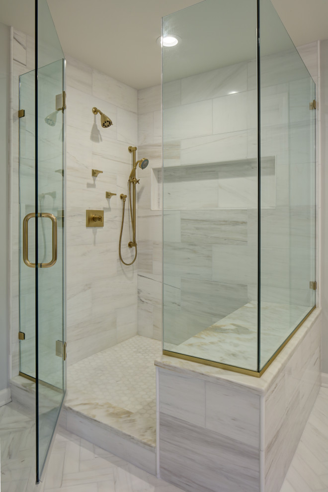 Photo of a transitional master bathroom in New York with shaker cabinets, a freestanding tub, a corner shower, a one-piece toilet, gray tile, marble, grey walls, marble floors, an undermount sink, quartzite benchtops, white floor, a hinged shower door, white benchtops, a shower seat, a double vanity and a freestanding vanity.