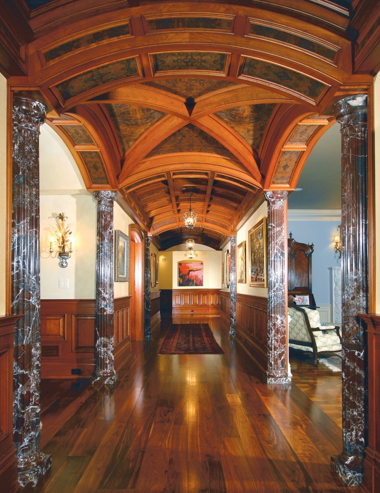 Expansive arts and crafts hallway in New York with beige walls and dark hardwood floors.