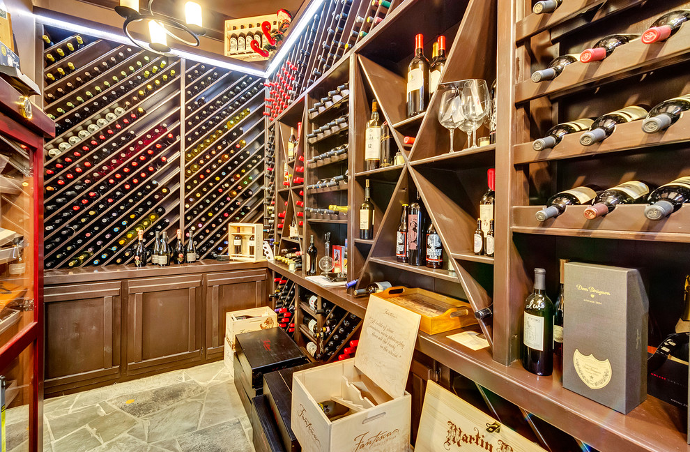 Traditional wine cellar in Dallas with slate floors and display racks.