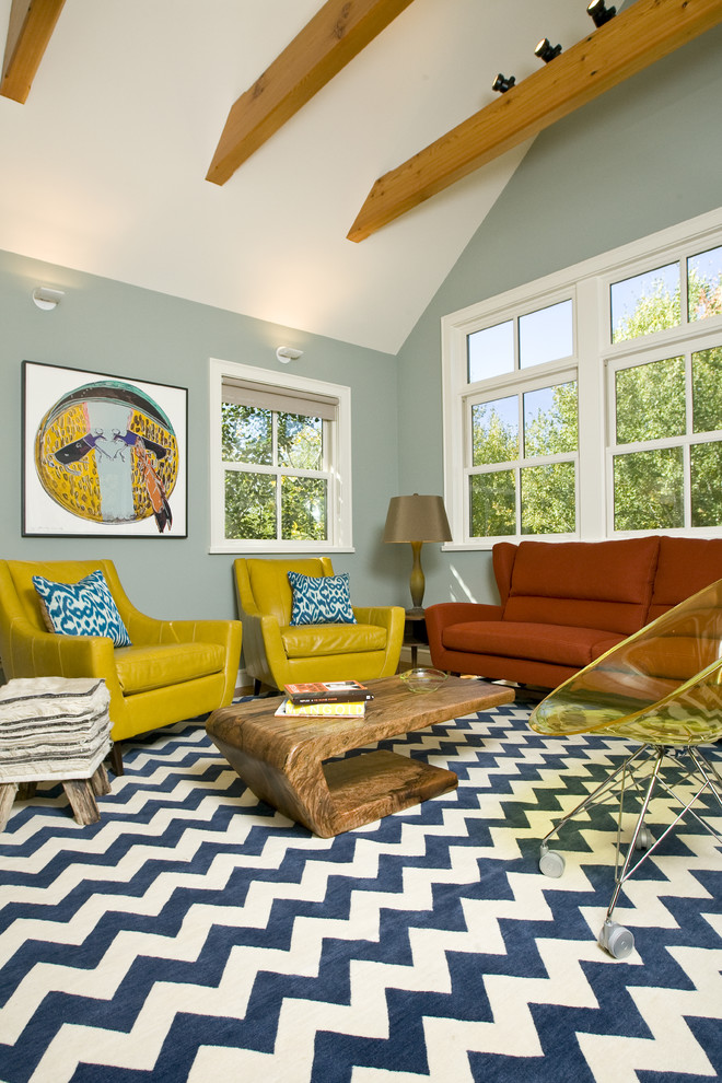 This is an example of an eclectic enclosed living room in Other with blue walls.