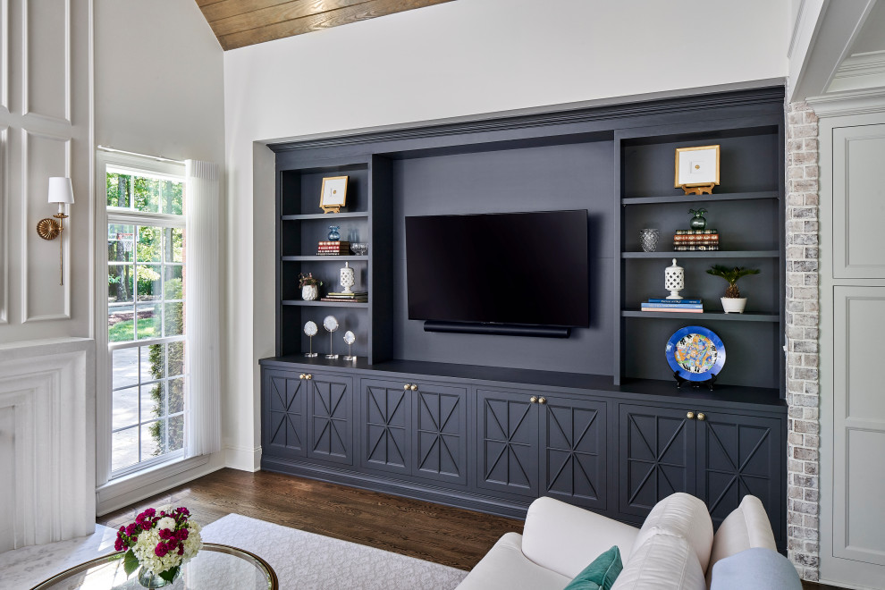 Inspiration for a small transitional formal and open concept dark wood floor, brown floor, vaulted ceiling and brick wall living room remodel in Charlotte with white walls, a standard fireplace, a stone fireplace and a media wall