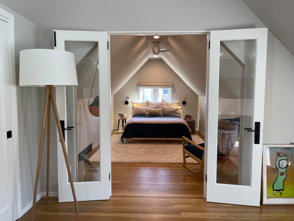 Inspiration for a mid-sized scandinavian loft-style light wood floor bedroom remodel with gray walls