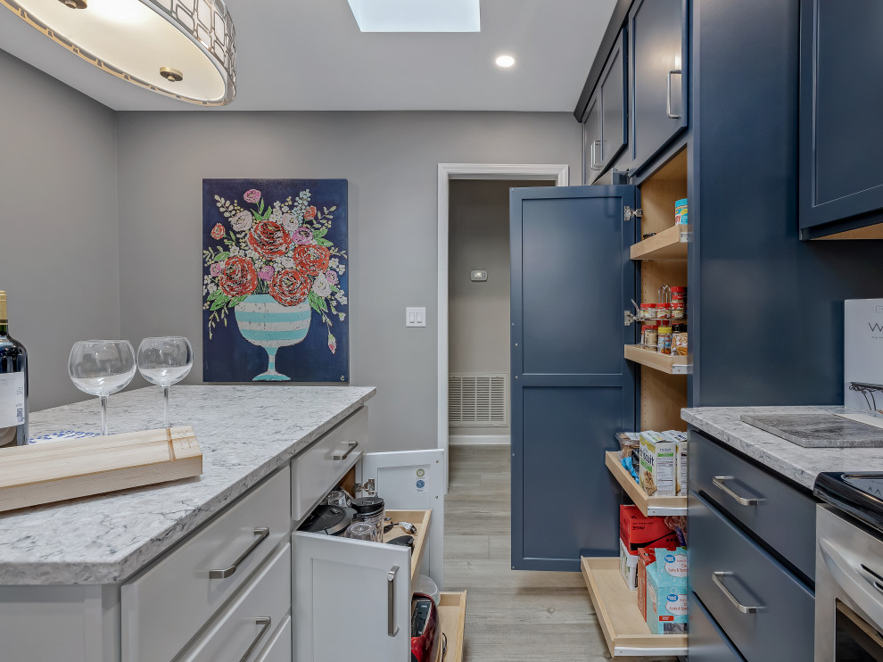 Inspiration for a large transitional l-shaped kitchen remodel in Raleigh with an undermount sink, recessed-panel cabinets, quartz countertops, porcelain backsplash, stainless steel appliances and an island