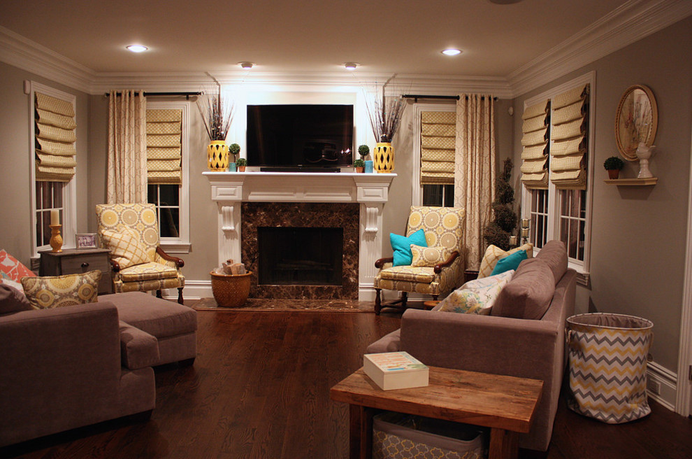 Photo of a mid-sized transitional open concept living room in New York with grey walls, dark hardwood floors, a standard fireplace, a tile fireplace surround, a wall-mounted tv and brown floor.