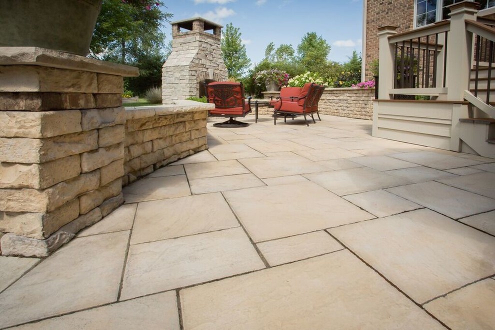 Inspiration for a mid-sized transitional backyard patio in Chicago with a fire feature, concrete pavers and no cover.