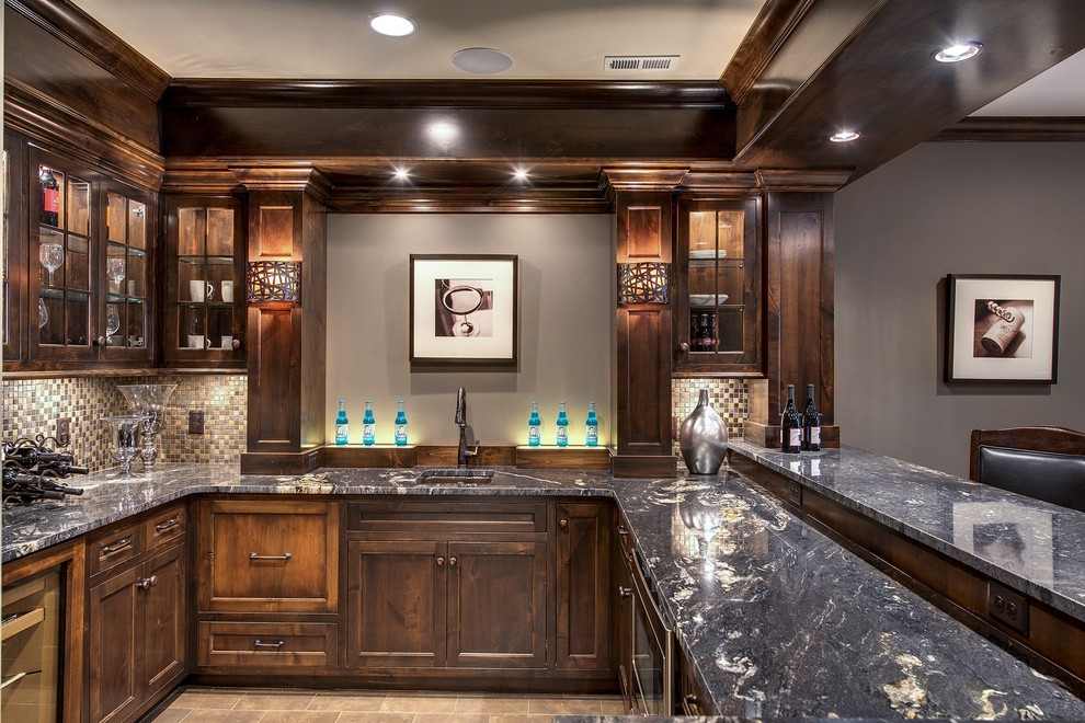 This is an example of a large traditional u-shaped seated home bar in Minneapolis with an undermount sink, shaker cabinets, dark wood cabinets, multi-coloured splashback and mosaic tile splashback.