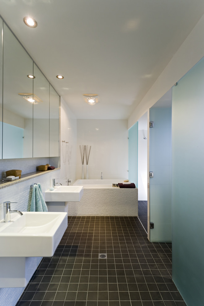 Small contemporary master bathroom in Brisbane with a wall-mount sink, engineered quartz benchtops, an alcove shower, a one-piece toilet, white tile, ceramic tile, white walls, porcelain floors and a drop-in tub.