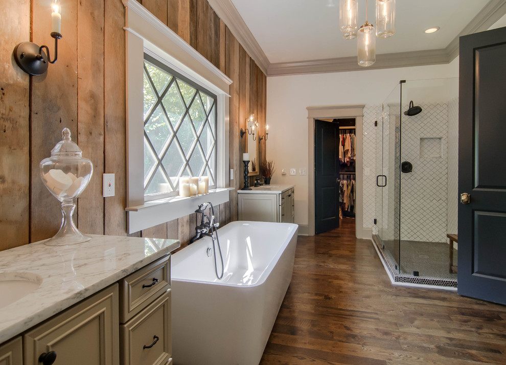 Inspiration for a transitional bathroom in Nashville with an undermount sink, recessed-panel cabinets, beige cabinets, a freestanding tub, a corner shower and white tile.