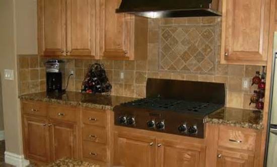 Inspiration for a timeless kitchen remodel in Austin with beaded inset cabinets, light wood cabinets, beige backsplash and stainless steel appliances