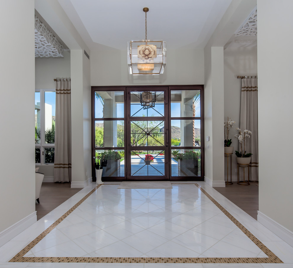 Mid-sized contemporary front door in Phoenix with beige walls, marble floors, a single front door, a metal front door and white floor.