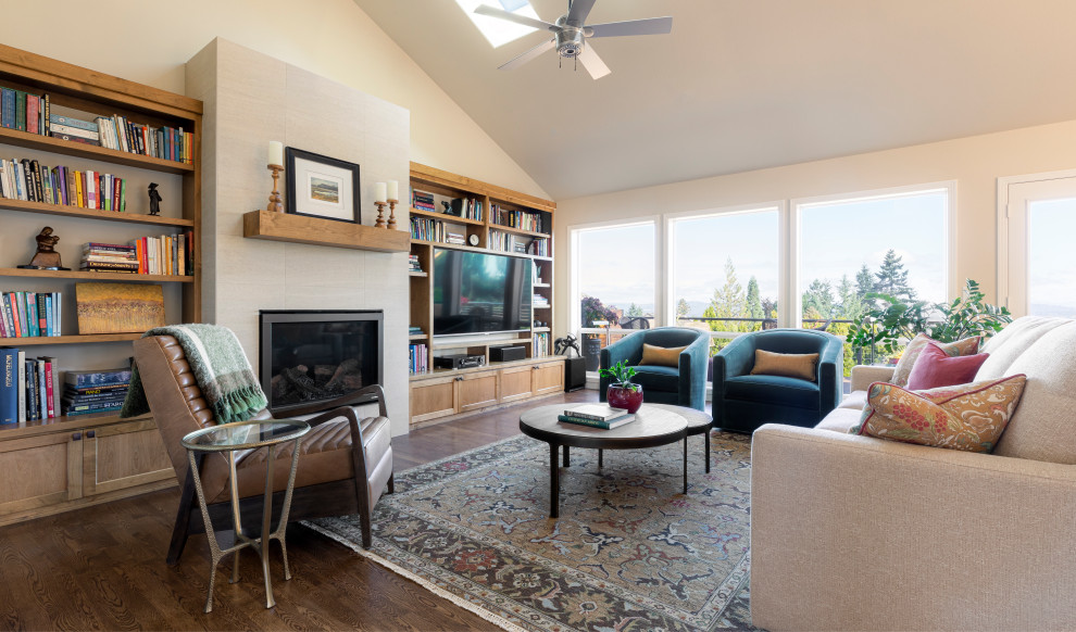 This is an example of a large transitional open concept family room in Portland with beige walls, medium hardwood floors, a standard fireplace, a tile fireplace surround, a built-in media wall and vaulted.
