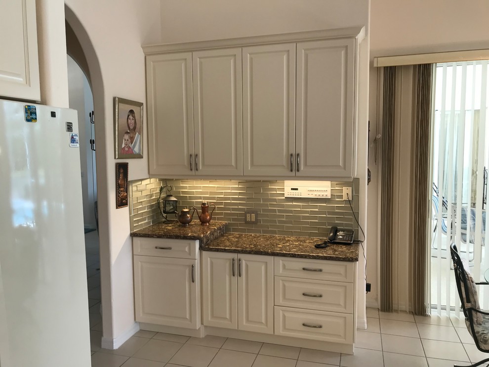 Large traditional l-shaped eat-in kitchen in Tampa with an undermount sink, raised-panel cabinets, beige cabinets, granite benchtops, brown splashback, glass tile splashback and brown benchtop.