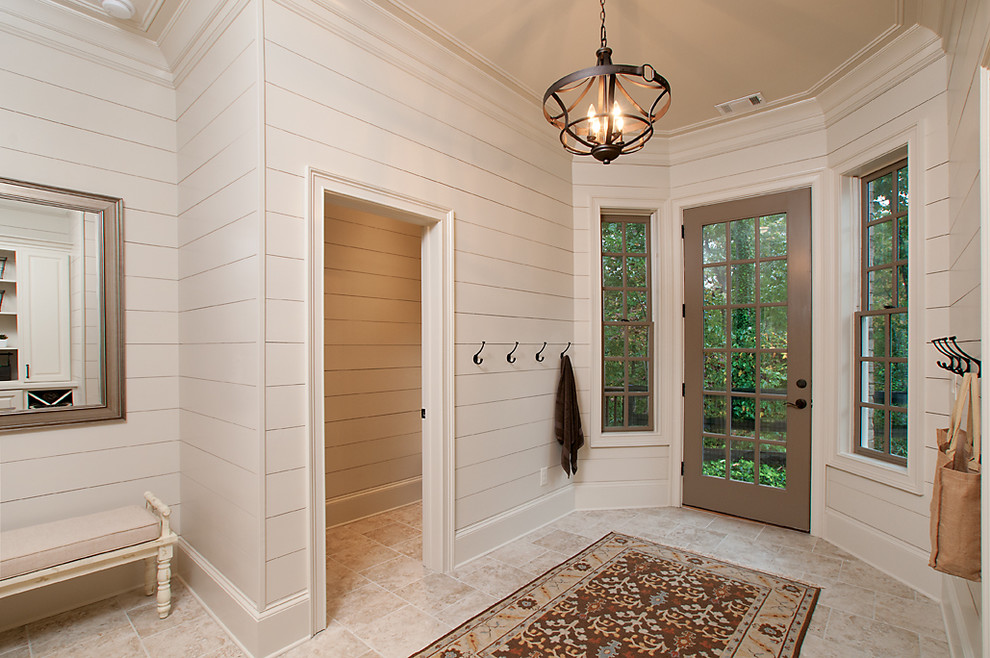 This is an example of a traditional mudroom in Atlanta with a single front door and a glass front door.