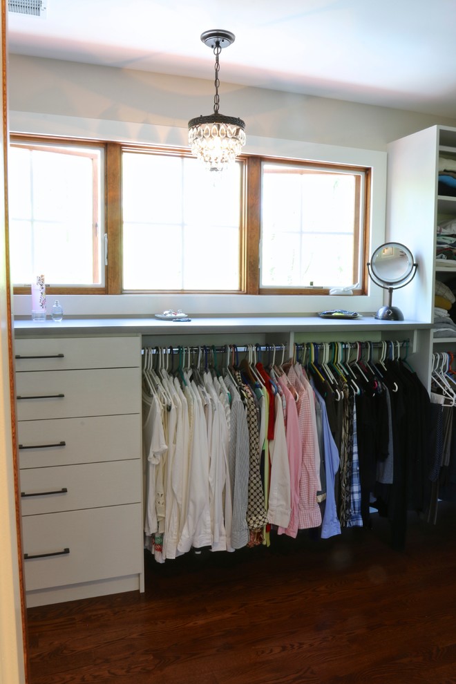 Design ideas for a mid-sized traditional gender-neutral walk-in wardrobe in Grand Rapids with flat-panel cabinets, white cabinets and dark hardwood floors.