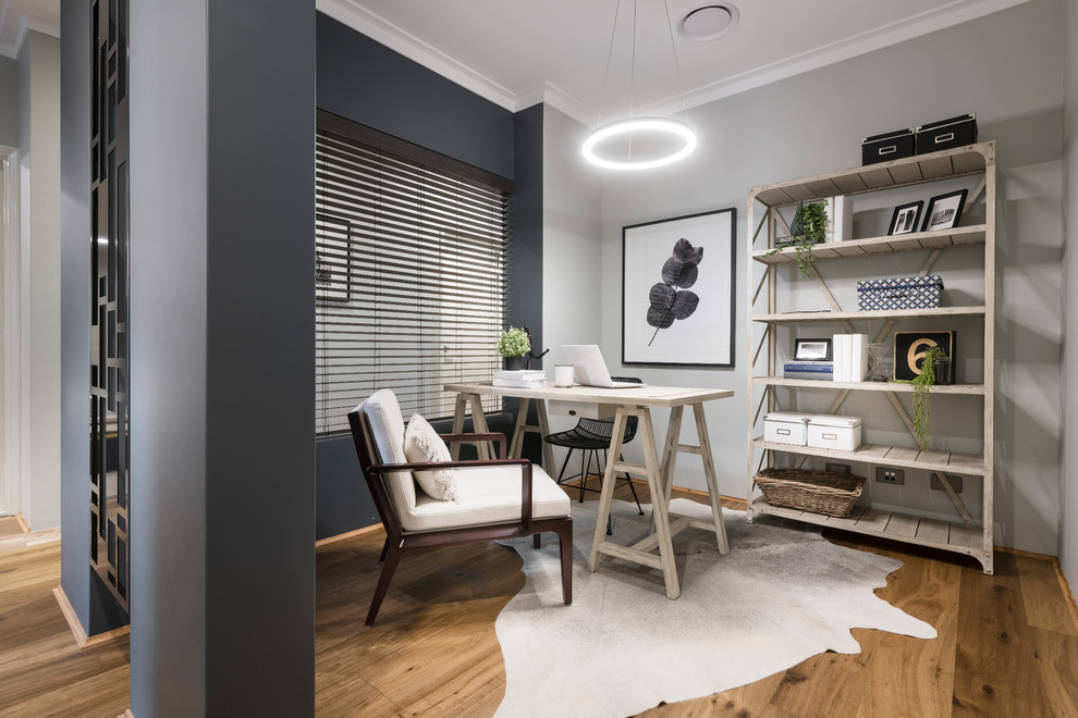 This is an example of a beach style study room in Perth with medium hardwood floors, a freestanding desk and brown floor.