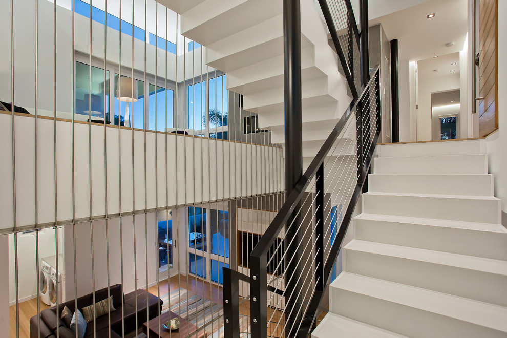 This is an example of a contemporary staircase in Tampa with cable railing.