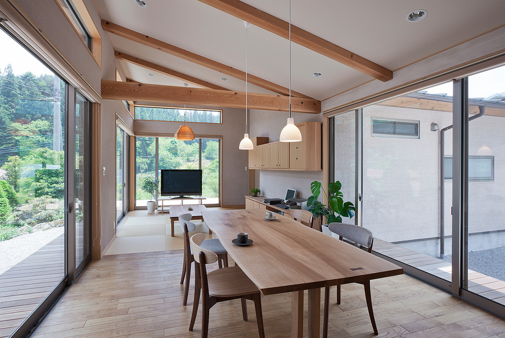 Photo of a mid-sized contemporary open plan dining in Other with white walls, light hardwood floors and no fireplace.