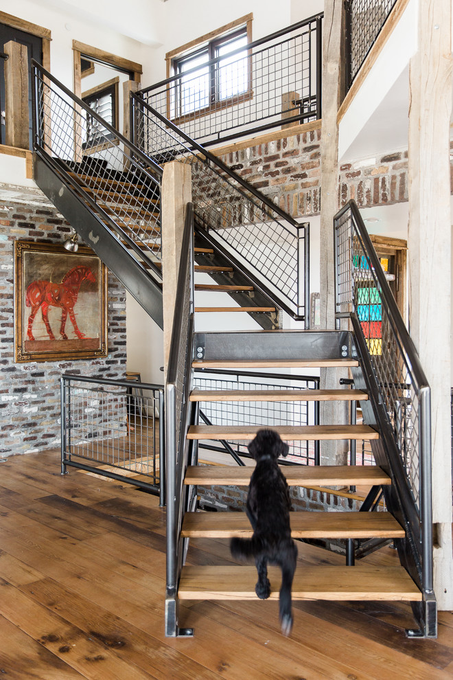 Design ideas for an industrial wood l-shaped staircase in Salt Lake City with open risers and metal railing.