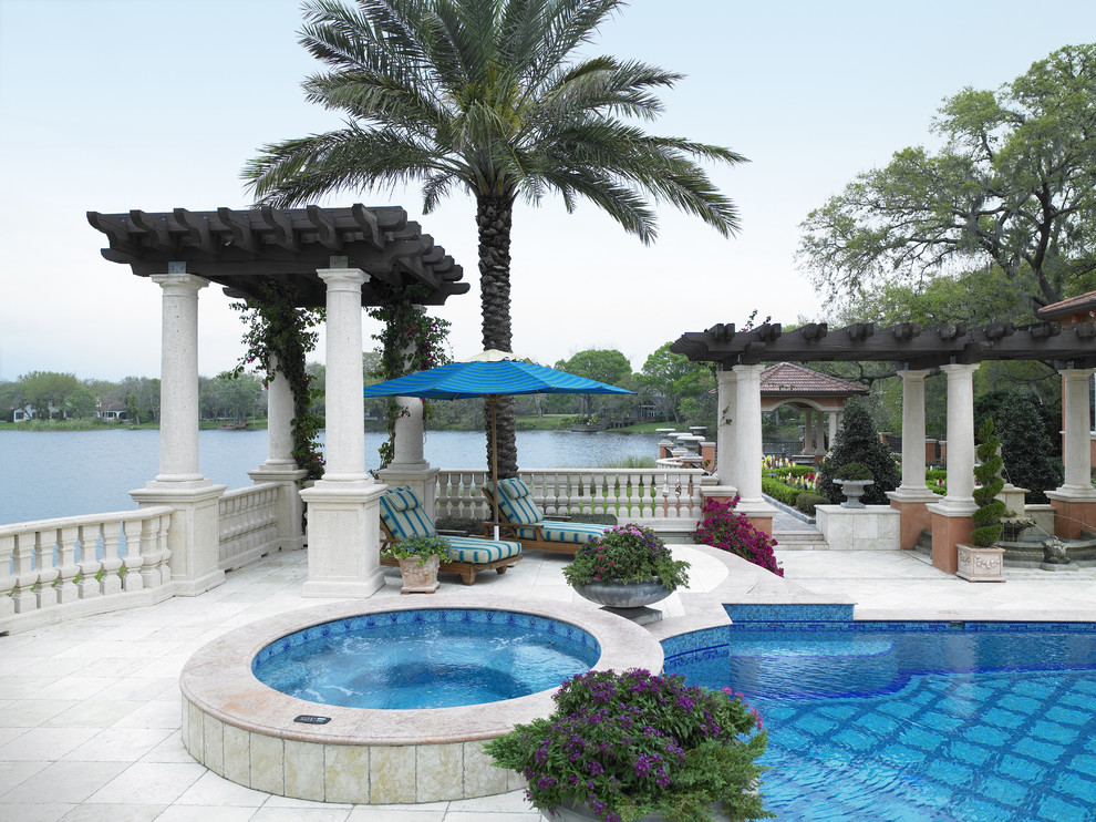This is an example of a mediterranean pool in Tampa with a hot tub.
