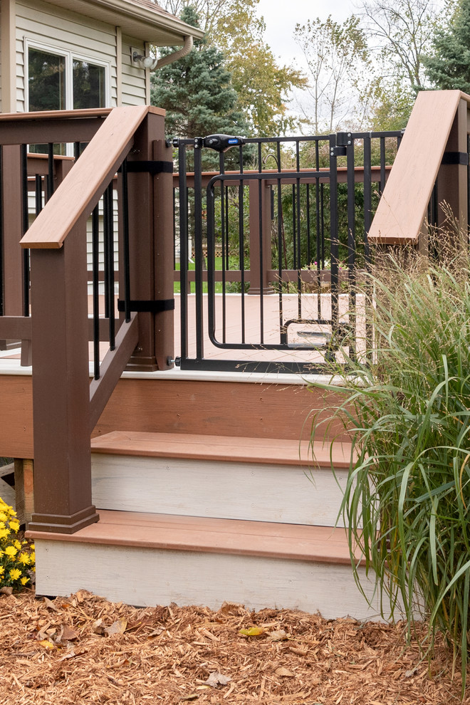 Inspiration for a mid-sized transitional backyard deck remodel with no cover