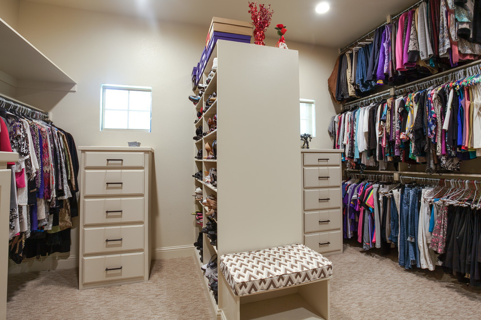 Design ideas for a large traditional gender-neutral dressing room in Dallas with louvered cabinets, white cabinets and carpet.