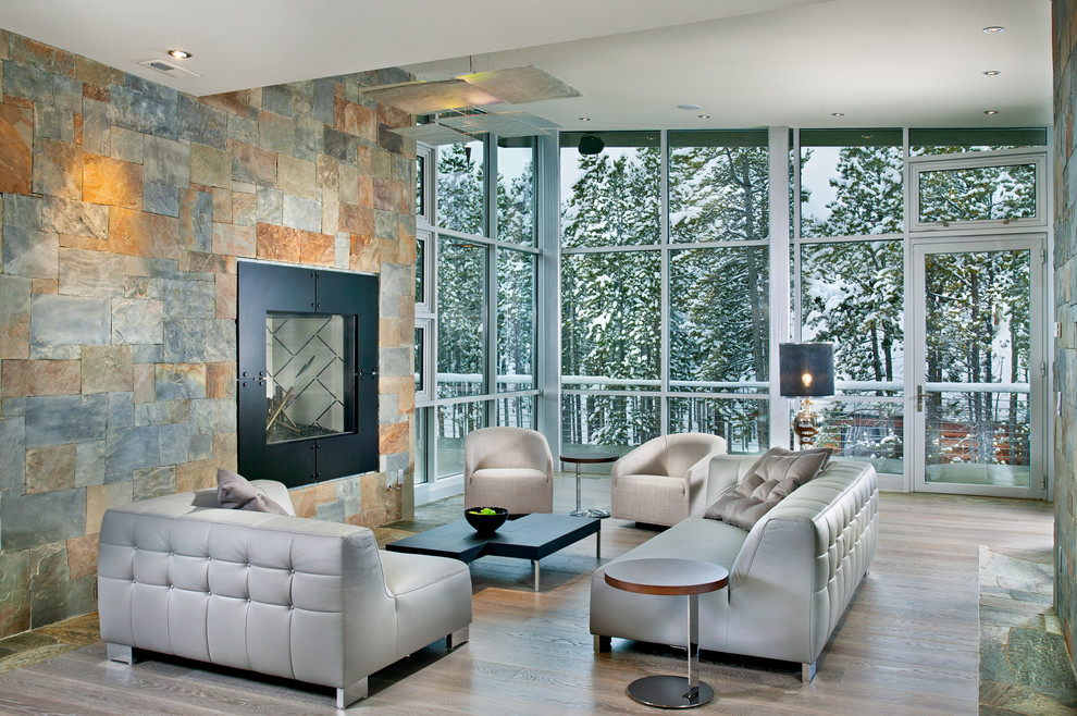 Design ideas for an expansive contemporary formal open concept living room in Atlanta with a stone fireplace surround, grey walls, a standard fireplace, light hardwood floors, no tv and grey floor.