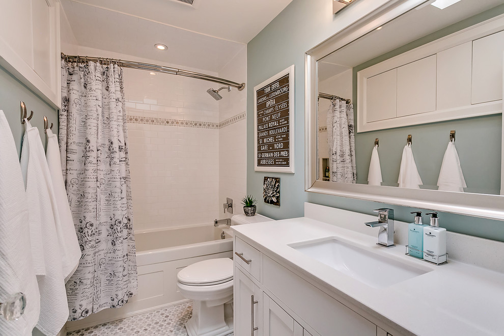 Small transitional master white tile and subway tile mosaic tile floor and multicolored floor drop-in bathtub photo in Toronto with shaker cabinets, white cabinets, green walls, an undermount sink, solid surface countertops and white countertops